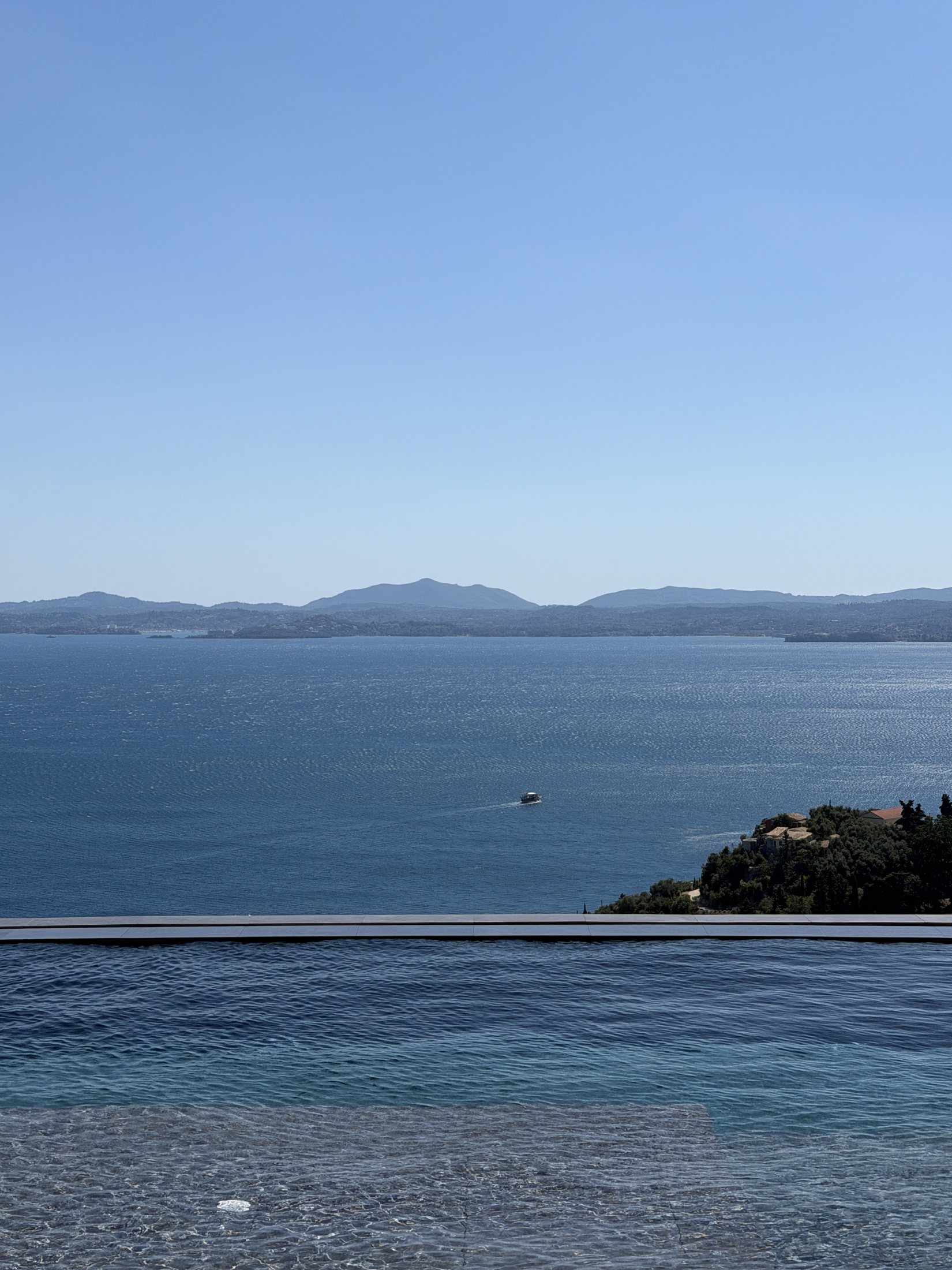 A panoramic Greek sea view from an infinity pool